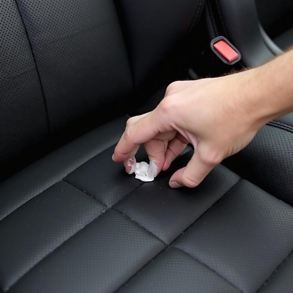 Applying Black Car Leather Seat Repair Cream to a Damaged Car Seat