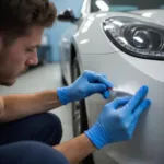 Applying Car Bumper Filler to a Dent