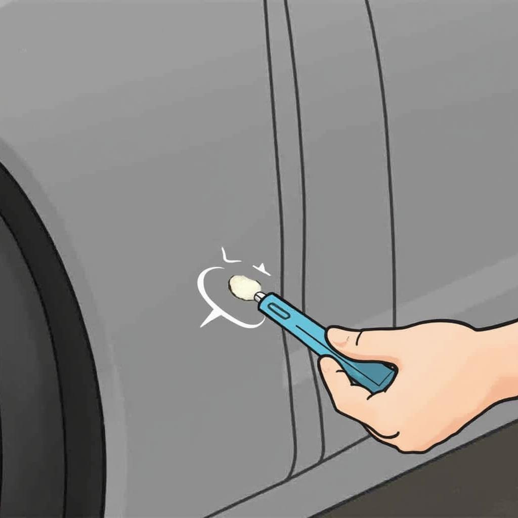 Applying car door molding repair compound to a crack.