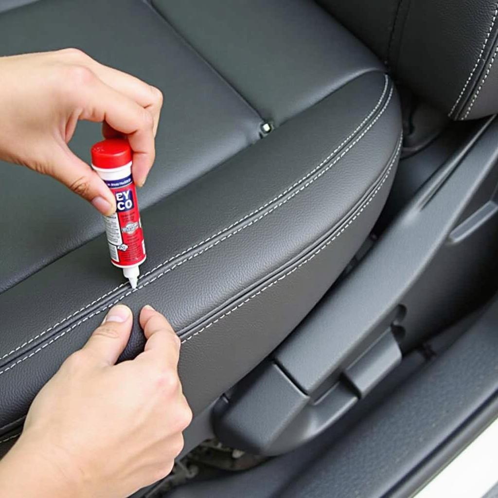 Applying Fabric Glue to Car Seat Tear