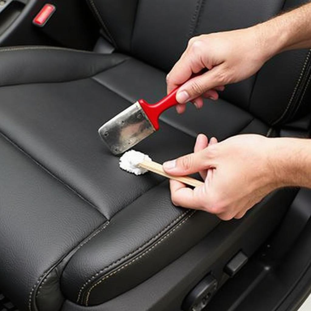 Applying leather filler compound to a ripped car seat