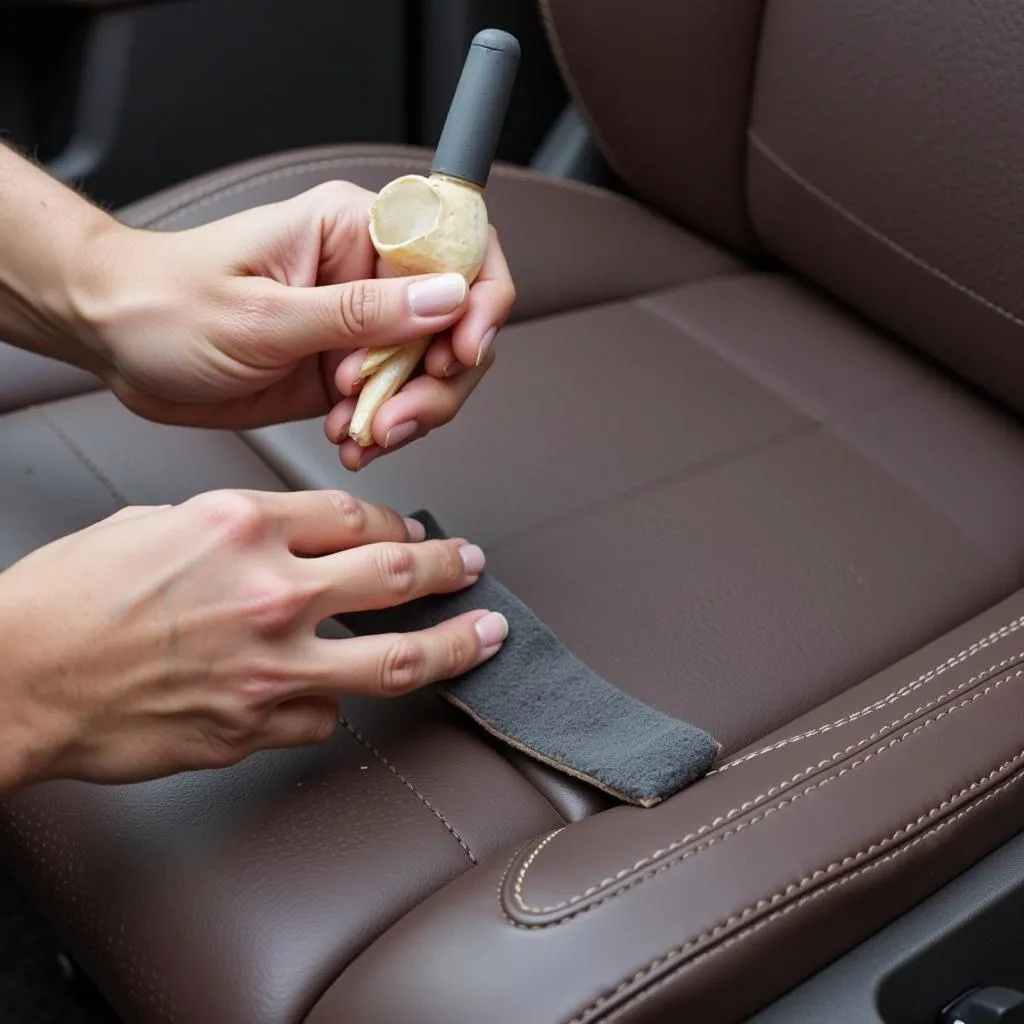 Applying leather repair compound on a car seat