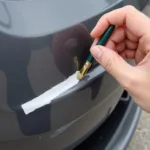 Applying Touch-Up Paint on Car Bumper