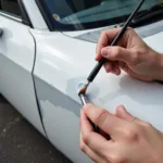 Applying touch-up paint to a car paint chip