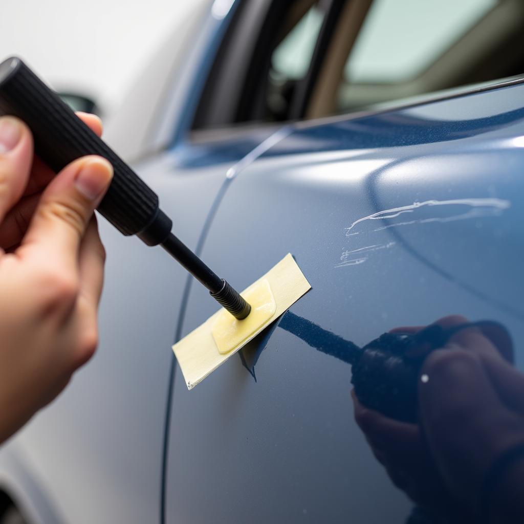 Applying touch-up paint to a car scratch using a precision applicator