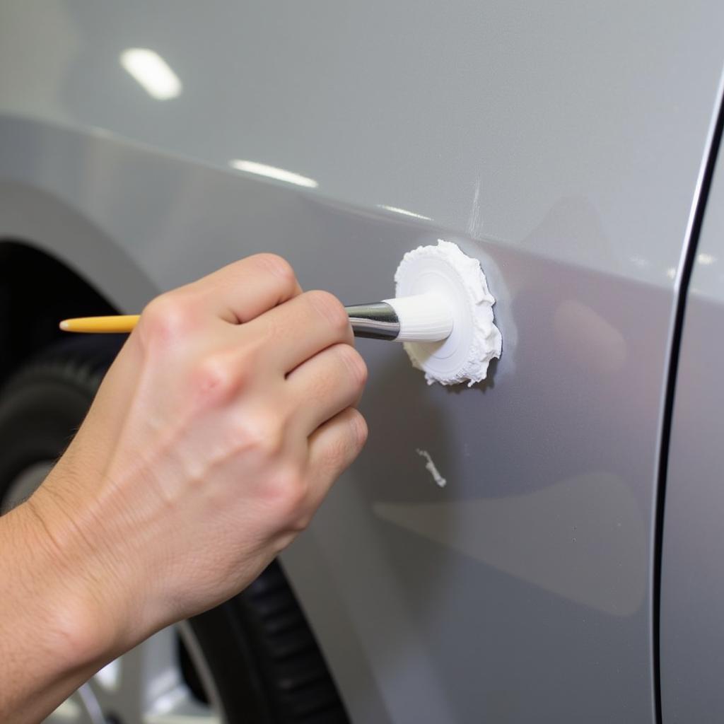 Applying touch-up paint to a car scratch