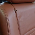 Close-up view of a small rip in a leather car seat