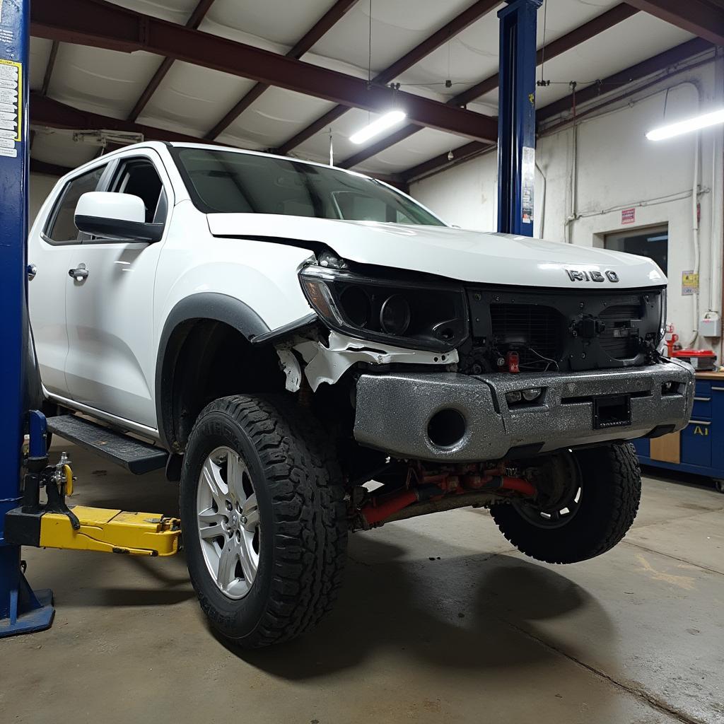 Car body repair shop in Corby with a damaged car on a lift