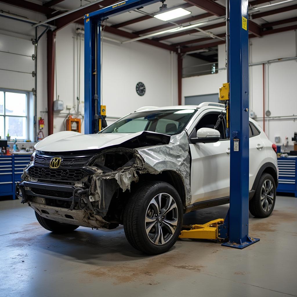 Car body repair shop in Llandeilo with a damaged car on a lift