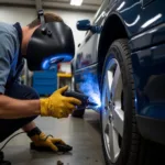 Car Body Sill Patching Process: A mechanic is patching a small rust hole on a car sill using a welding tool.