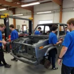 Students practicing car bodywork repair techniques