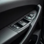 Close-up of car door interior with power window switch