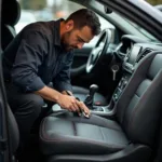 Car leather seat repair specialist working diligently in Glasgow