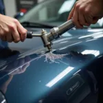 Car paint scratch repair in progress at a Manchester body shop