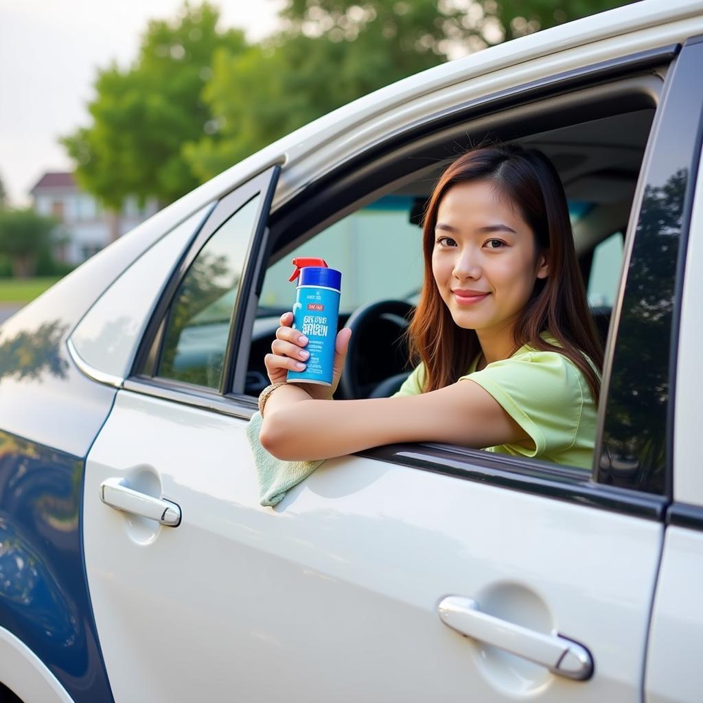  Person cleaning the window of a car with a microfiber cloth