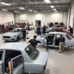 Students working on car body repair projects at Chesterfield College