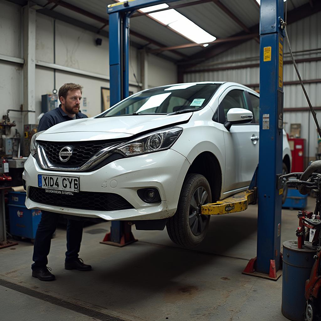 Car body shop in Chichester with a damaged car on a lift