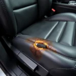 Close up of a cigarette burn on a leather car seat