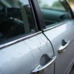 Close-up of cracked car door molding