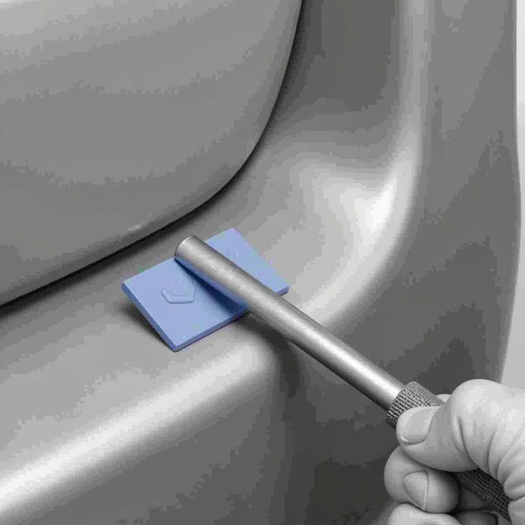 Glue pulling method being used to repair a dent on a car bumper