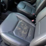 Heated car seat with visible damage and wear, indicating a malfunction.