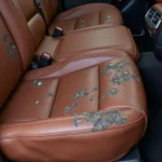 Leather car seat showing signs of wear and tear