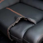 Leather car seat with a tear exposing the heating element