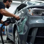 Mobile car paint repair technician working on a vehicle