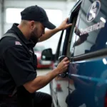 Technician performing mobile car window repair in Bakersfield