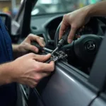 Mechanic inspecting car window mechanism