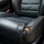 Close-up of a ripped leather car seat