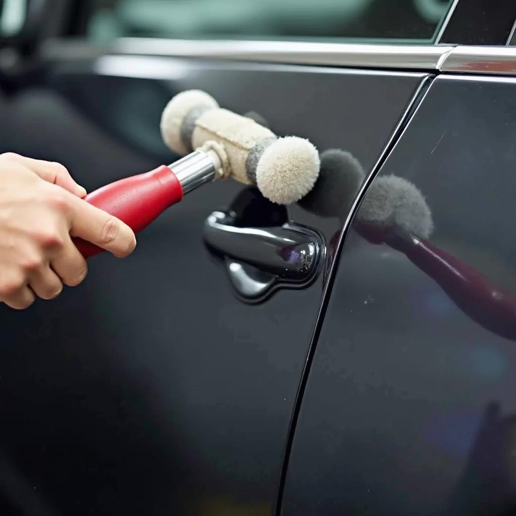  Using a slapping hammer to repair a car dent