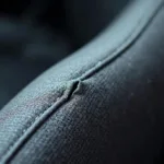 Close-up of a small tear in a cloth car seat