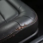 Close-up of a torn leather car seat