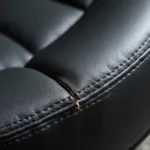 Close-up of a tear in a vinyl car seat