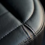 Close-up of a small tear in a vinyl car seat