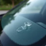 Close-up of a small chip in a car windshield