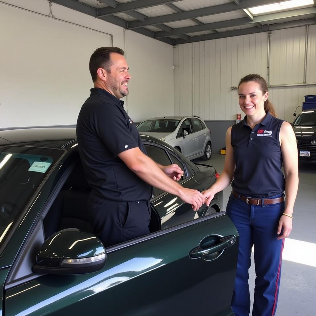 Happy Customer with Repaired Car at Andy Dale