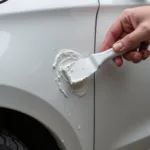 Applying Bondo to a Car Dent