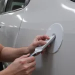 Applying Car Body Filler to a Dent