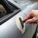 Applying Car Body Filler to a Hole