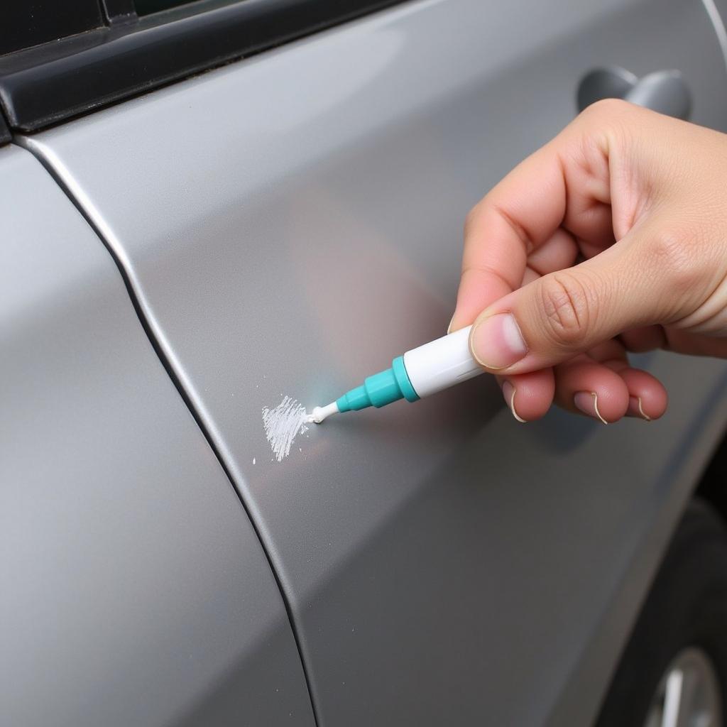 Applying Car Scratch Repair Pen to a Scratched Car Surface