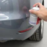 Applying clear coat to a car bumper after spray painting