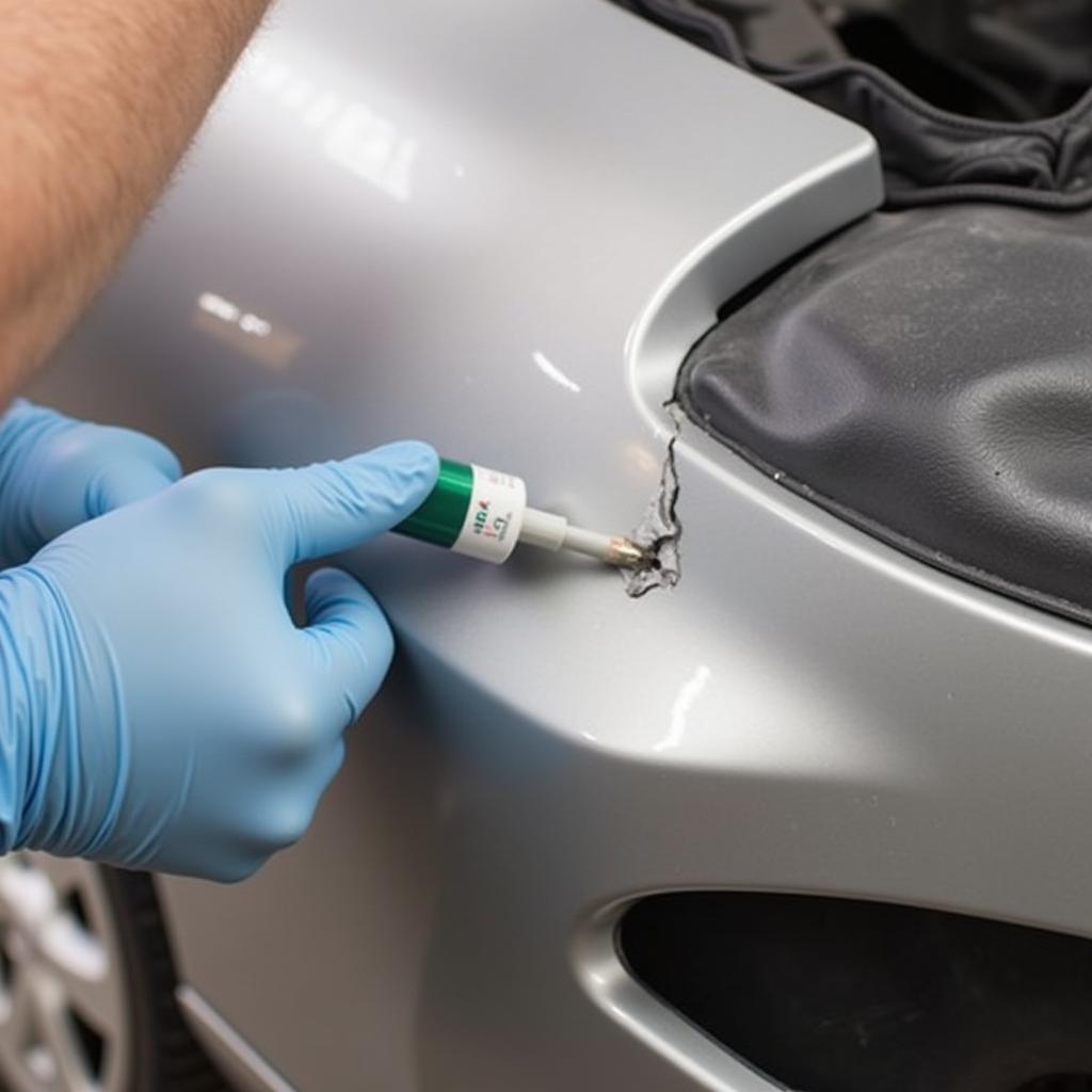 Applying Plastic Filler to Car Bumper