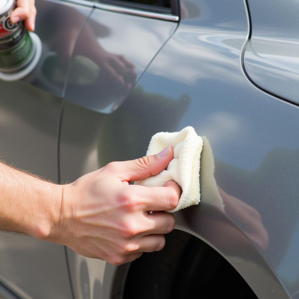 Applying Rubbing Compound to Car