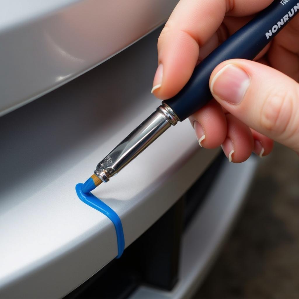 Applying Touch-Up Paint to a Car Bumper Scratch