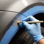 Applying touch-up paint to a car's rusted area