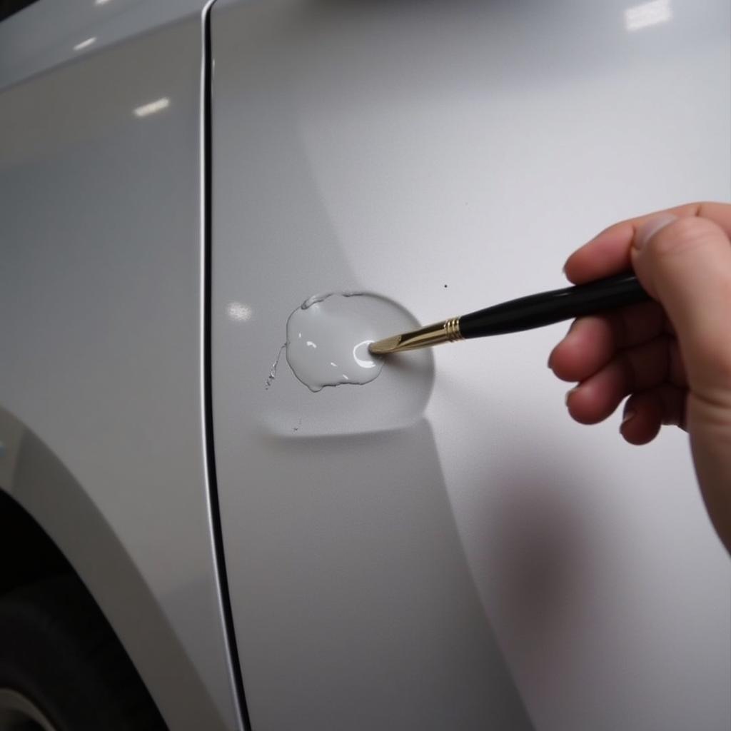 Applying touch-up paint to a car's chipped surface