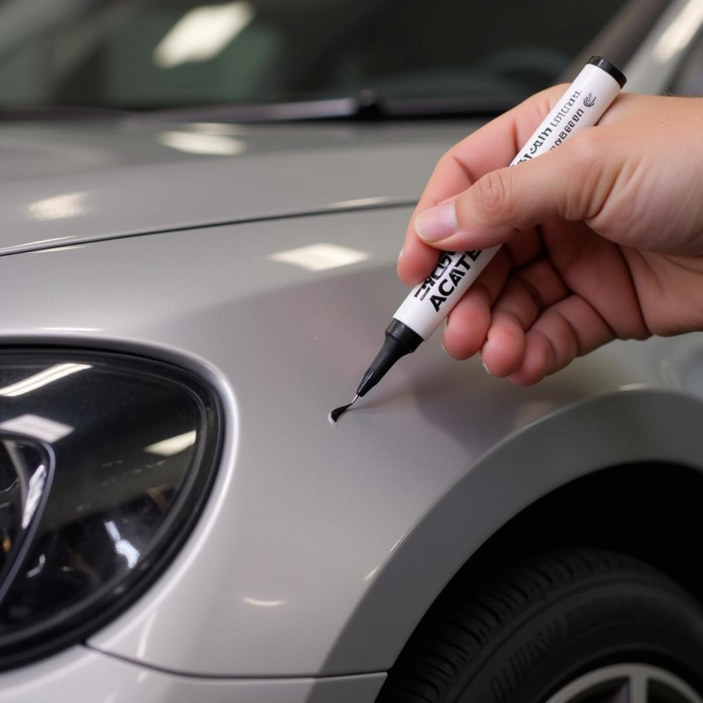 Applying touch-up paint to car chip in Swindon