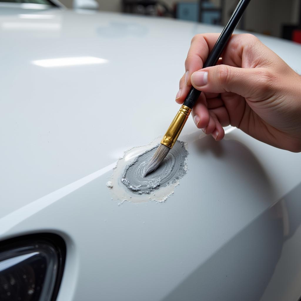 Applying touch-up paint to a car hood chip